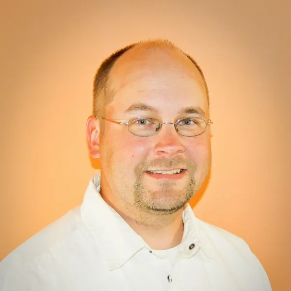 Todd Robertson, man with glasses and white shirt.